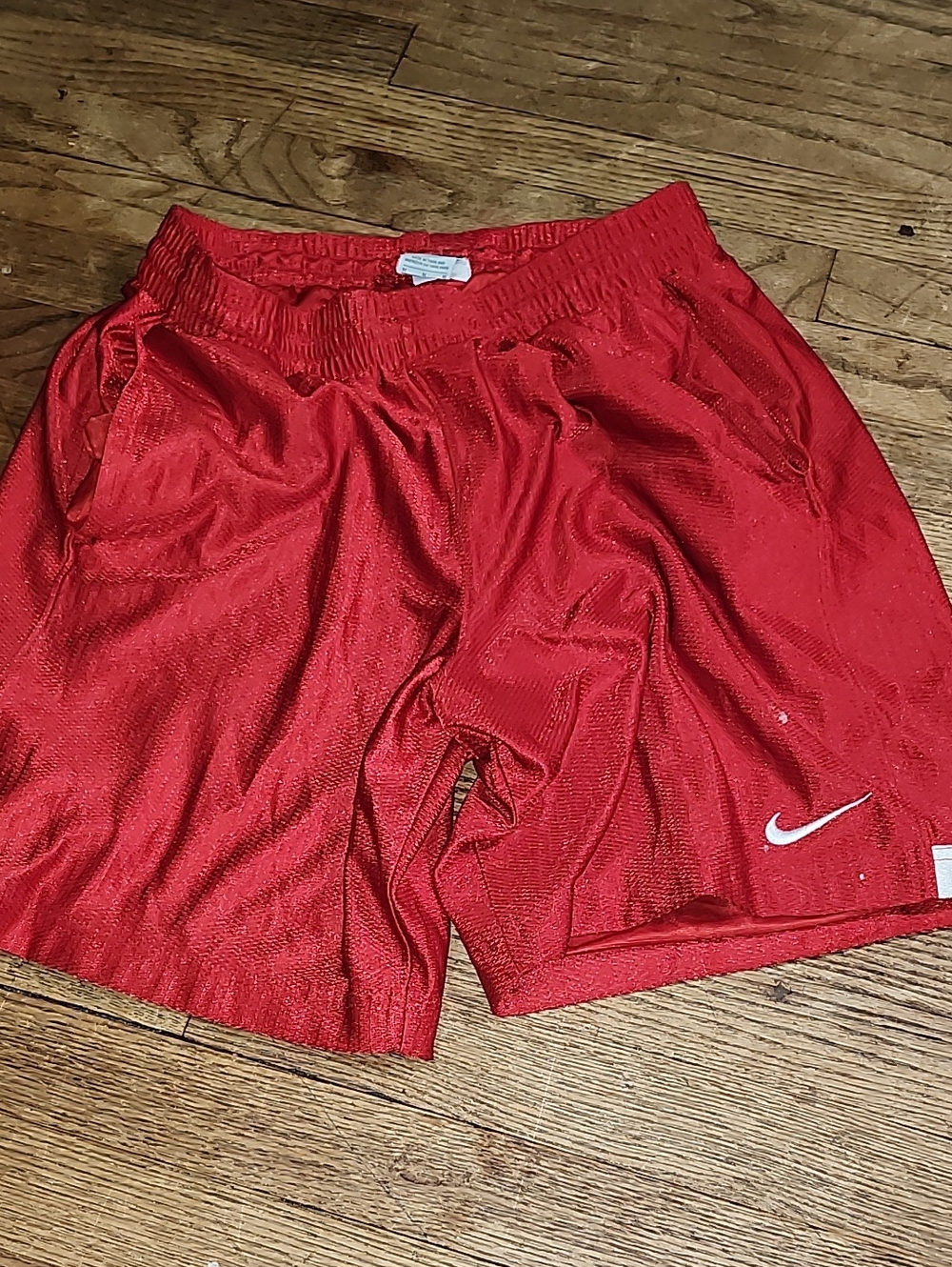 Nike Red Mesh Athletic Shorts with White Swoosh Accent